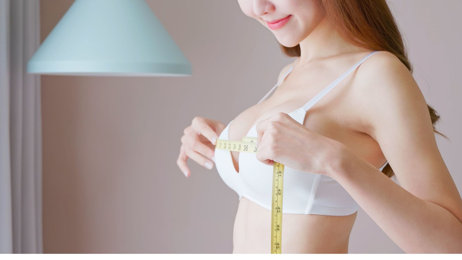 A woman measuring her cup size