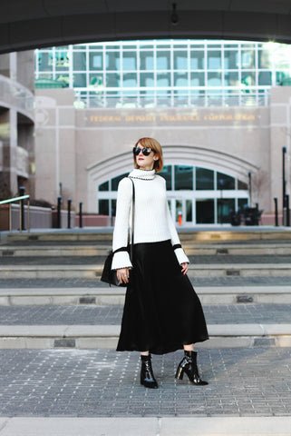 Satin skirt with a chunky knit sweater and ankle boots