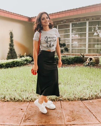 Satin skirt with a graphic tee and sneakers