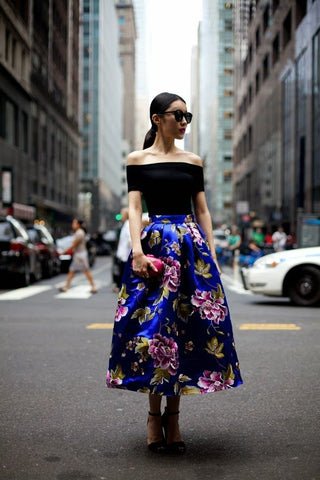 Satin skirt with an off-the-shoulder top and stilettos